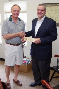 Dave Finney hands over the keys to Champlain College to Don Laackman